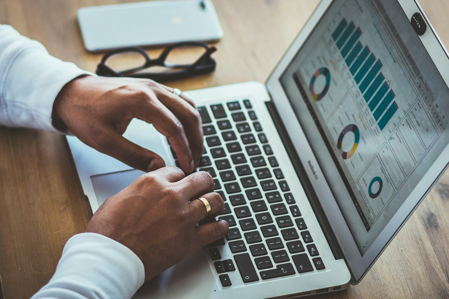 A business professional reviewing performance charts on a laptop before making a decision